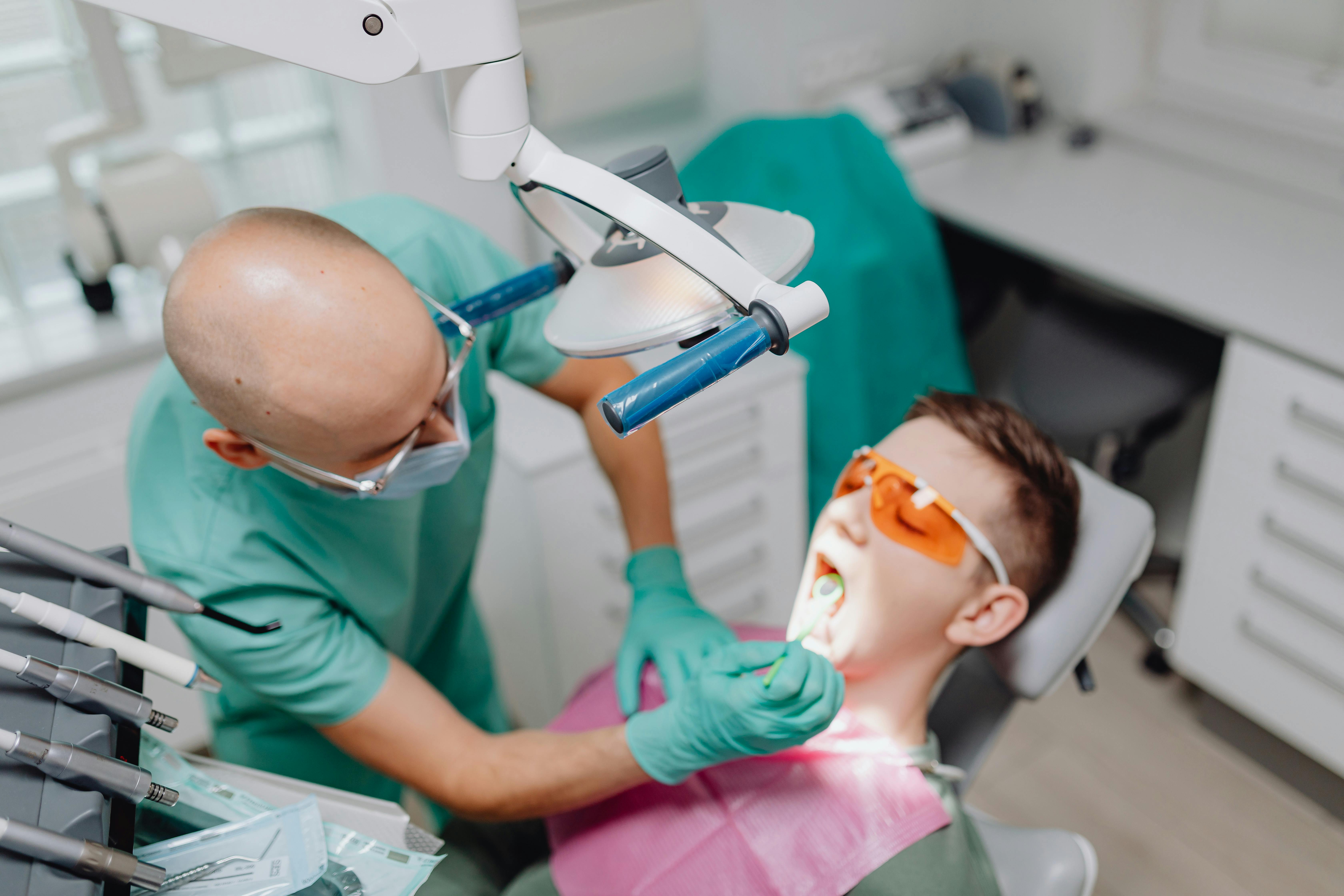 dentist curing patient teeth