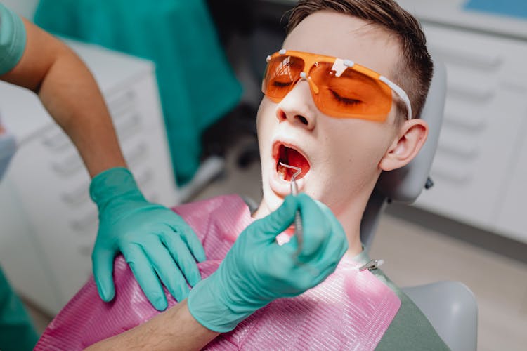 A Man With Open Mouth At Dental Clinic