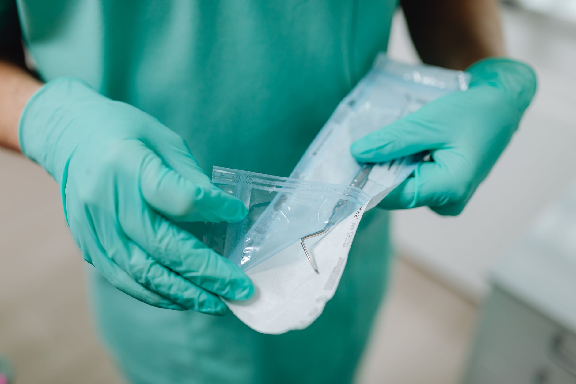 Hands of a Person Holding a Medical Tool