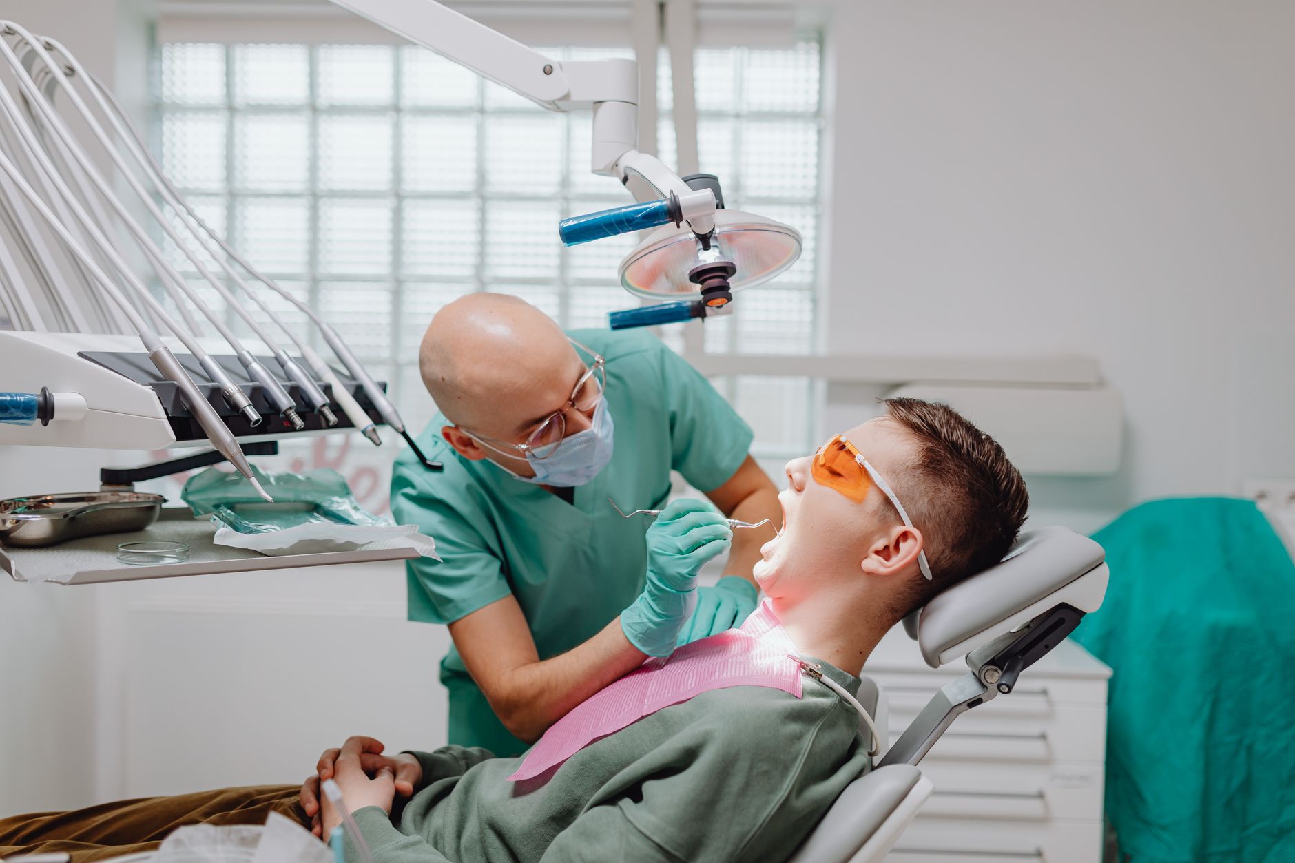 Patient receives dental check-up from experienced dentist in a modern clinic.