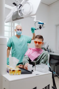 Professional dentist performing a dental checkup on a teenager in a modern clinic setting.