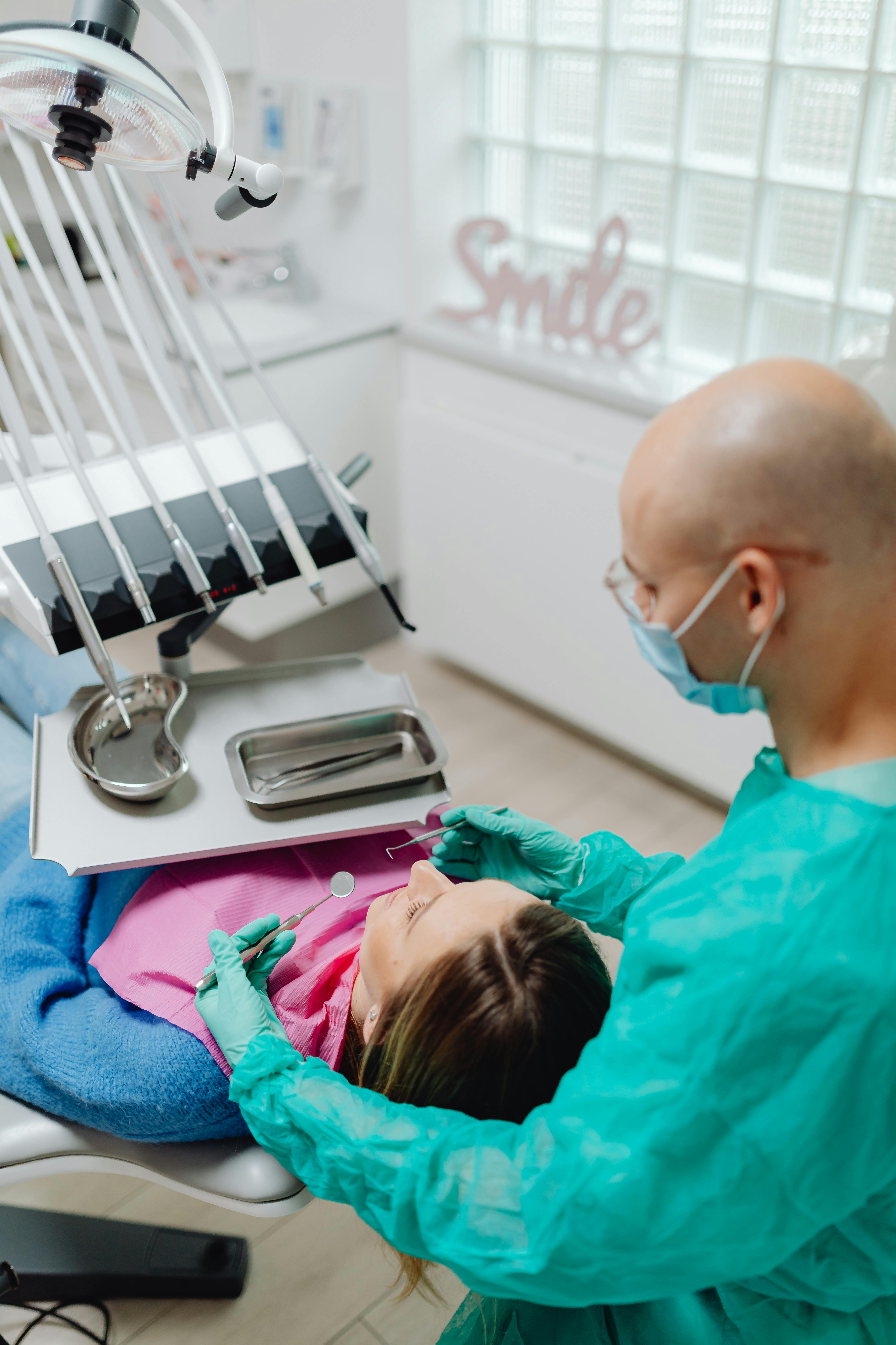 a dentist doing a dental procedure on a patient