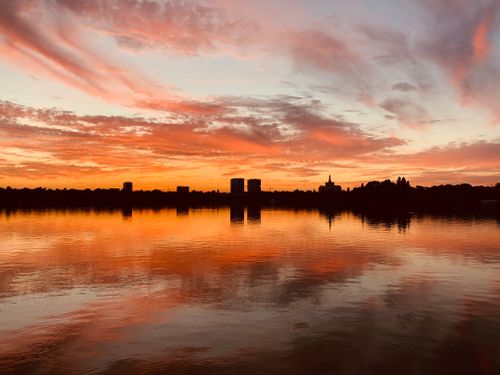 Free A breathtaking sunset over a cityscape silhouette in Bucharest, Romania. Stock Photo