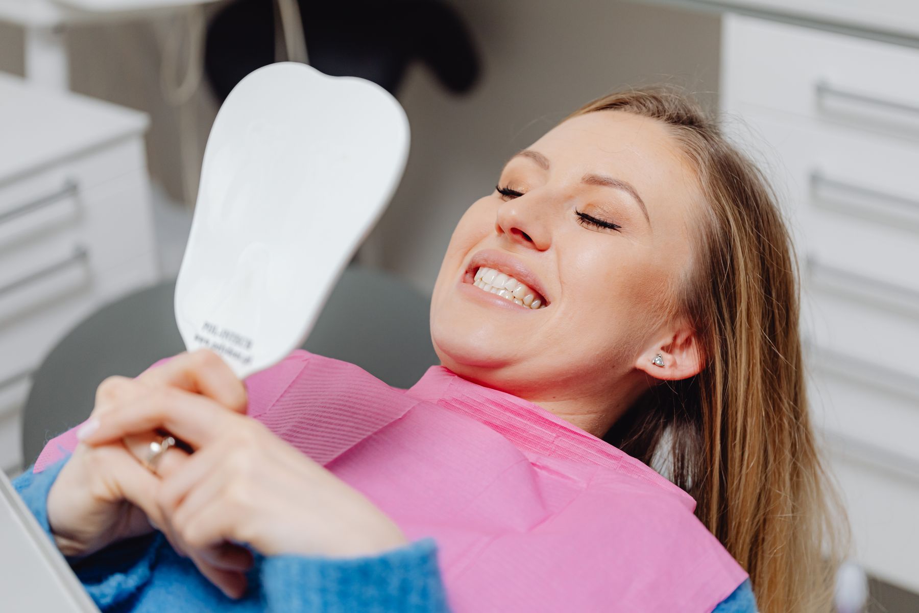 Paziente sorridente in studio dentistico moderno