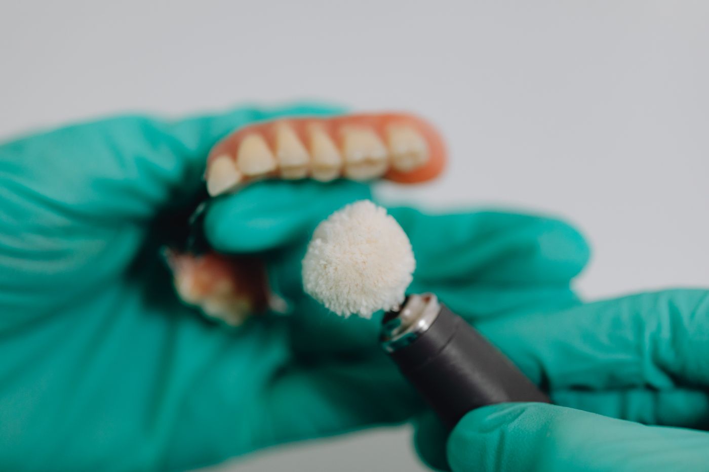 Dental professional finishing a removable denture