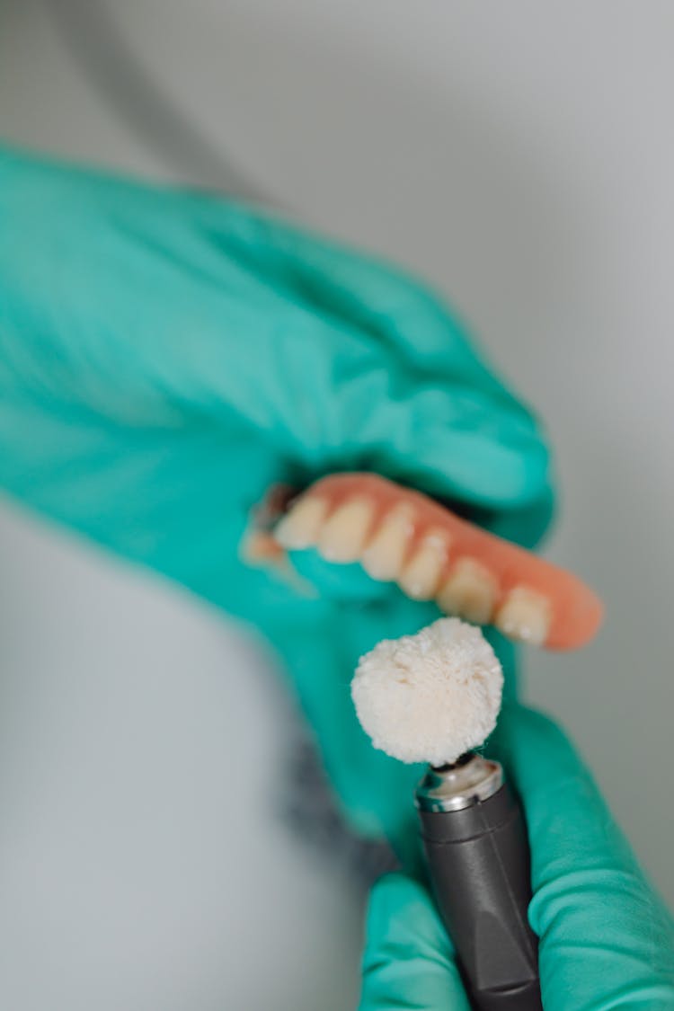 Close-up Of Dentist Polishing Teeth Implants