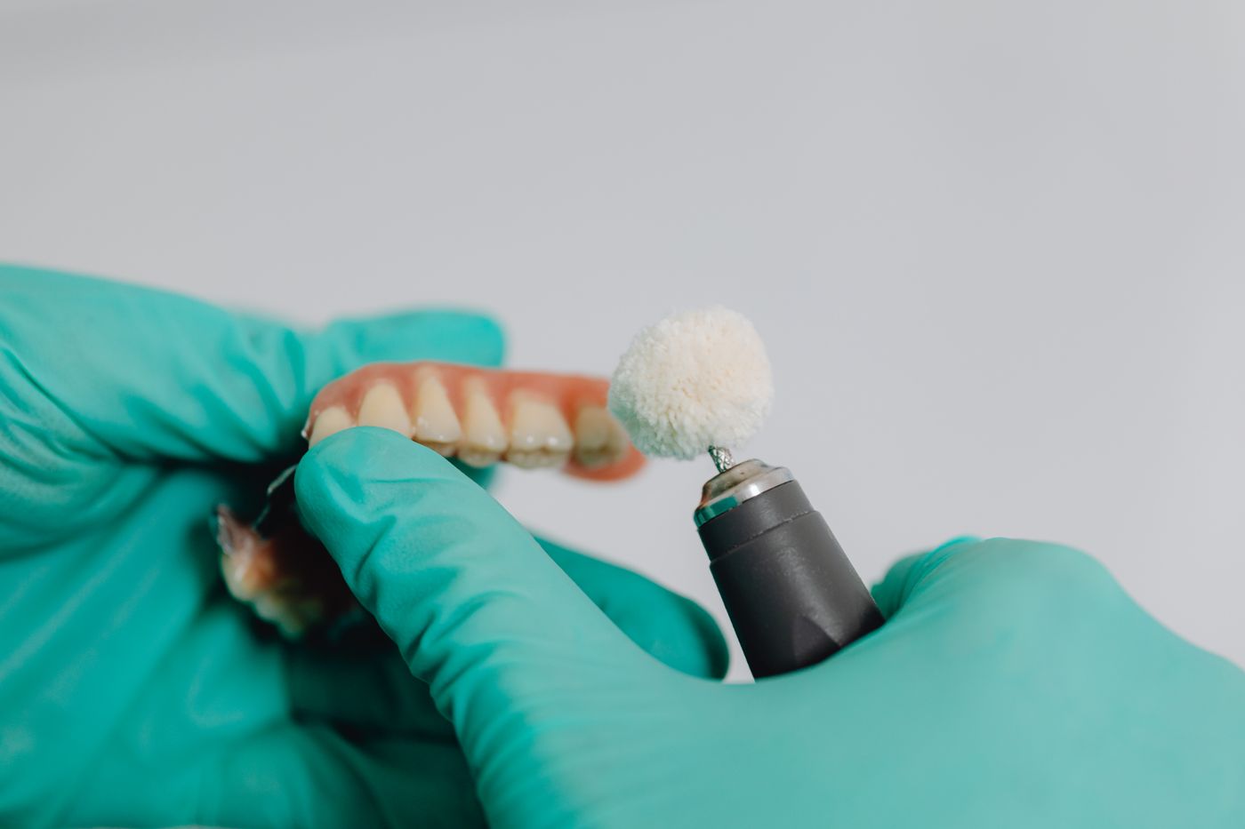 Precision finishing of a laboratory-made dental restoration