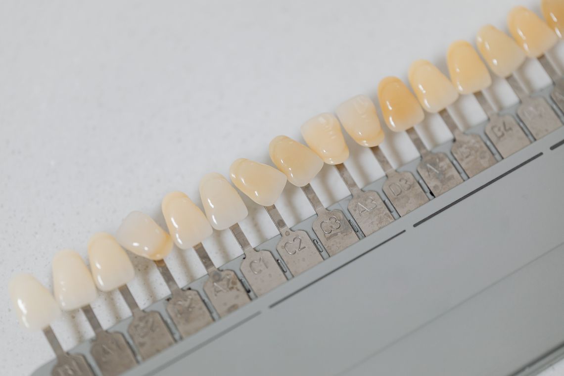 Dental floss, toothbrush, and oral care essentials arranged on a neutral surface