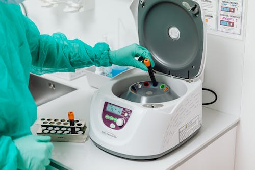 Doctor Using a Centrifuge Machine 