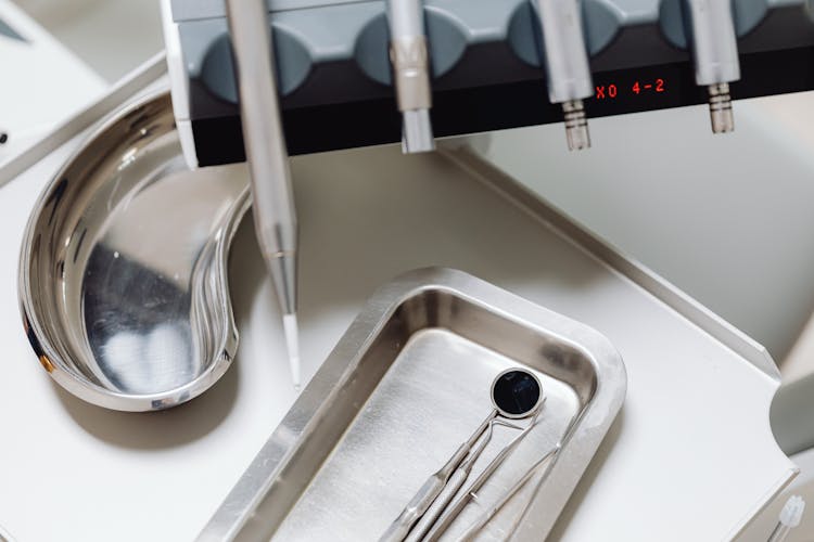 
A Close-Up Shot Of Dental Medical Instruments On A Silver Tray