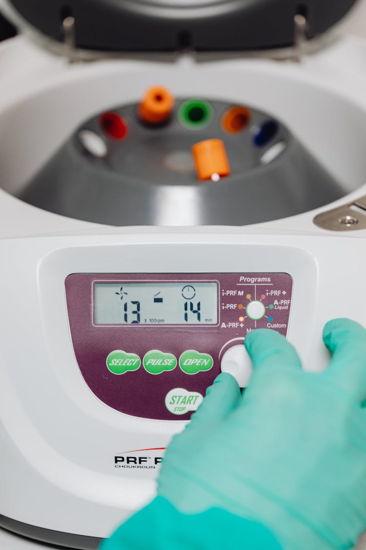 A Doctor Using A Centrifuge Machine