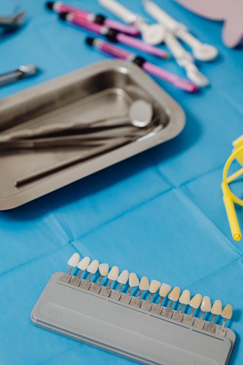Free Close-up of a dental shade guide with tools on a blue cloth surface. Stock Photo
