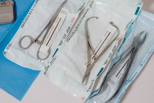 Close-up of sterilized surgical tools in packaging on a clinical table.