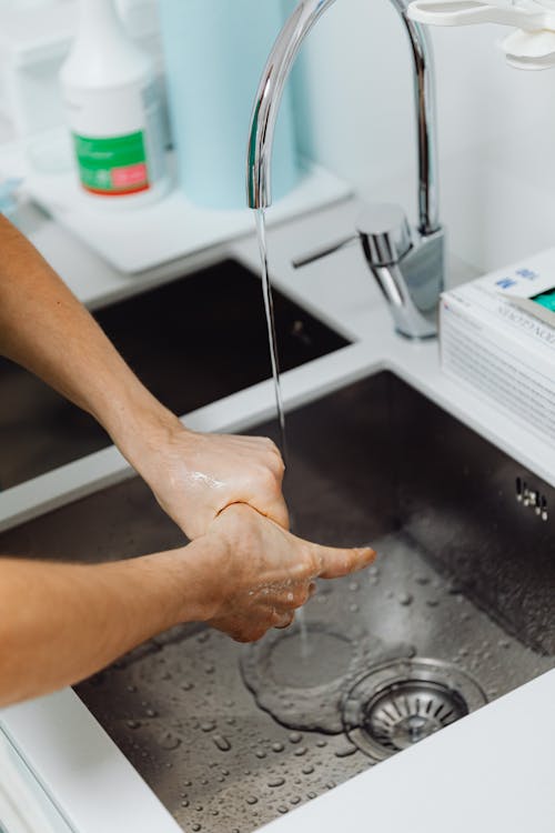 Free Person Cleaning his Hands Thoroughly Stock Photo