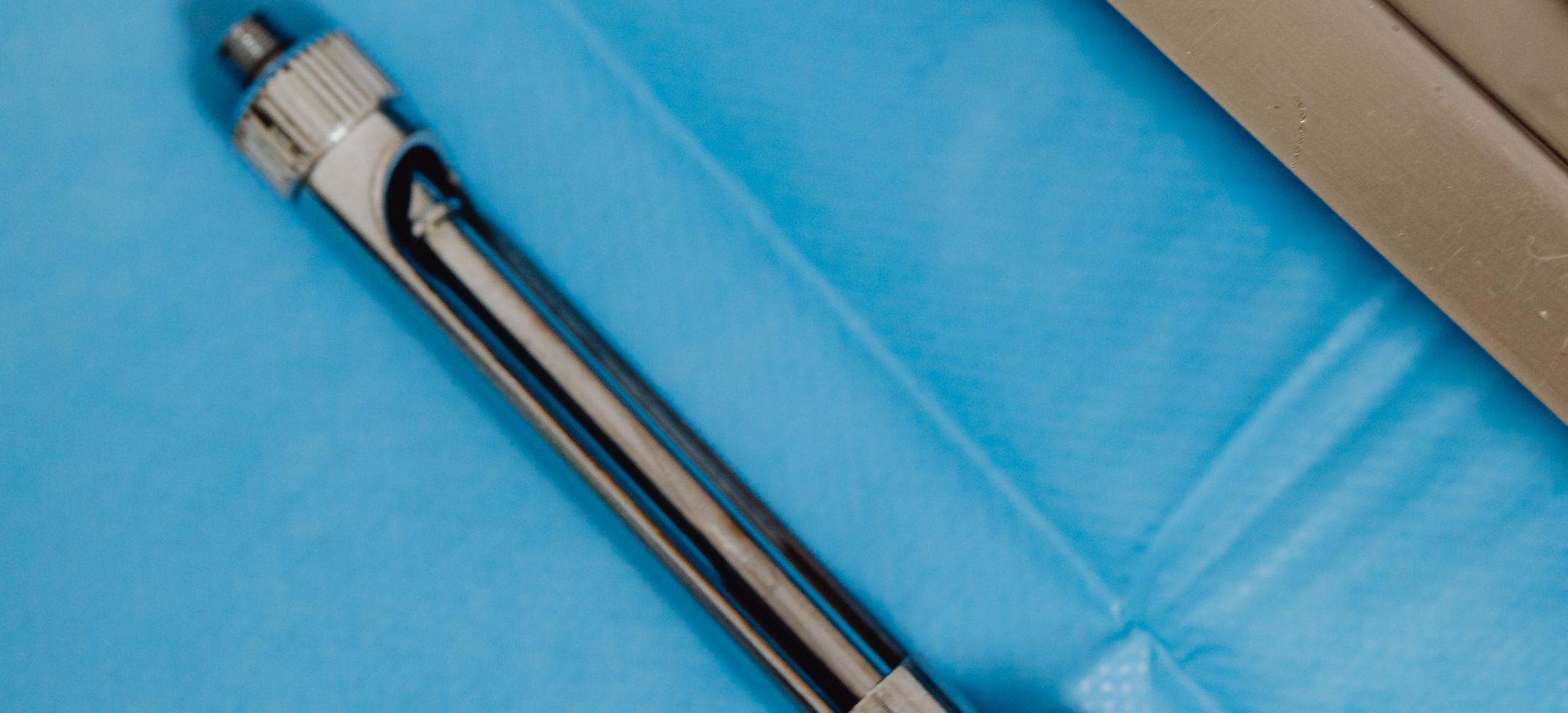 Extreme close-up of a sterile stainless steel surgical instrument