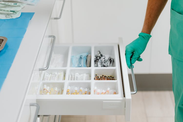 Doctor Opening Drawer With Instruments