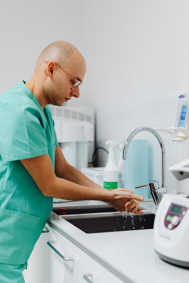 Doctor In Uniform Washing Hands