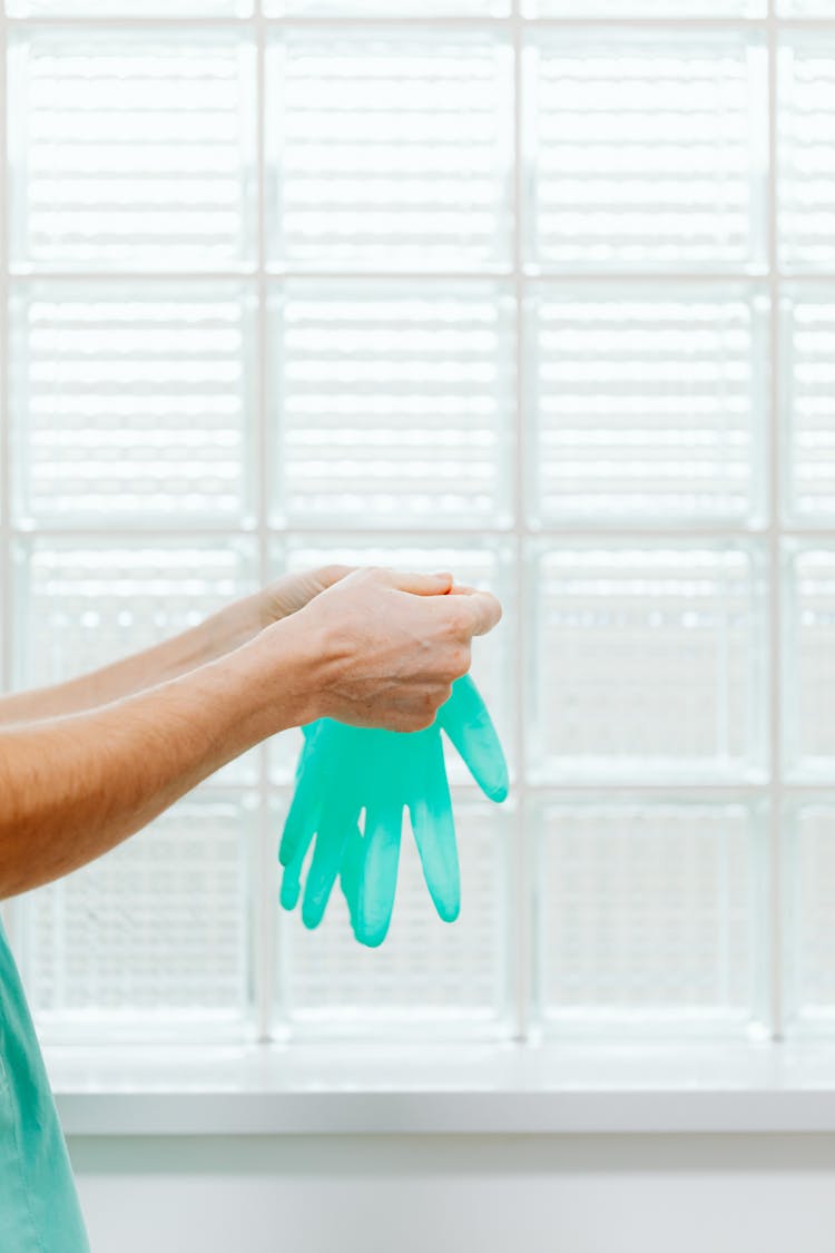 Doctor Putting On Surgical Gloves 