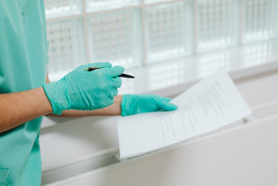 Close-up of a healthcare professional in gloves holding and reading a medical document indoors.