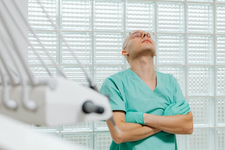 Doctor Standing With His Head Back In The Medical Examination Room 