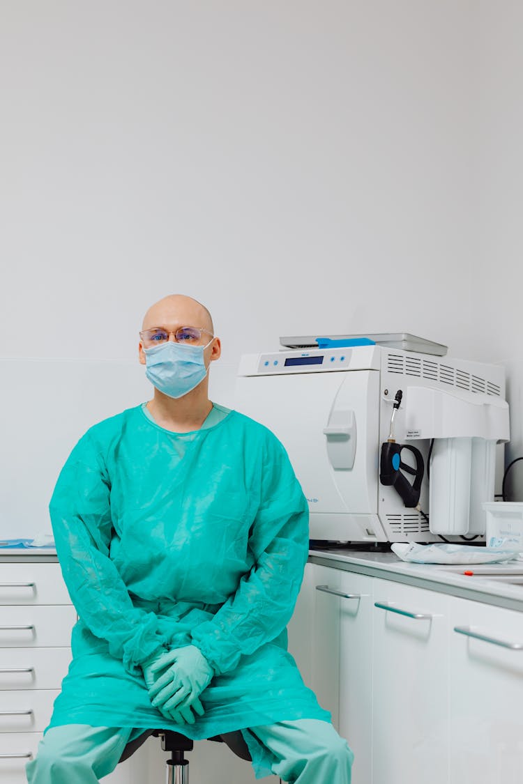 Dentist In Medical Uniform And Face Mask In Cabinet