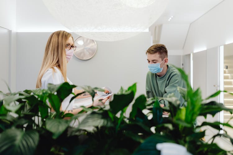 Woman And Man In Waiting Room In Clinic