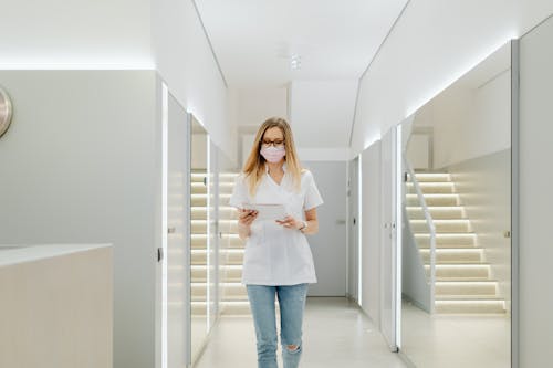 A Woman Walking on the Hallway