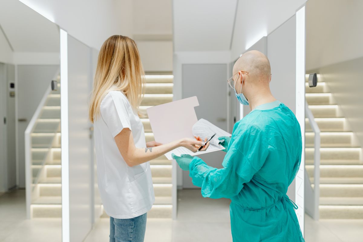 Healthcare professionals reviewing clinical documents together in a modern care setting