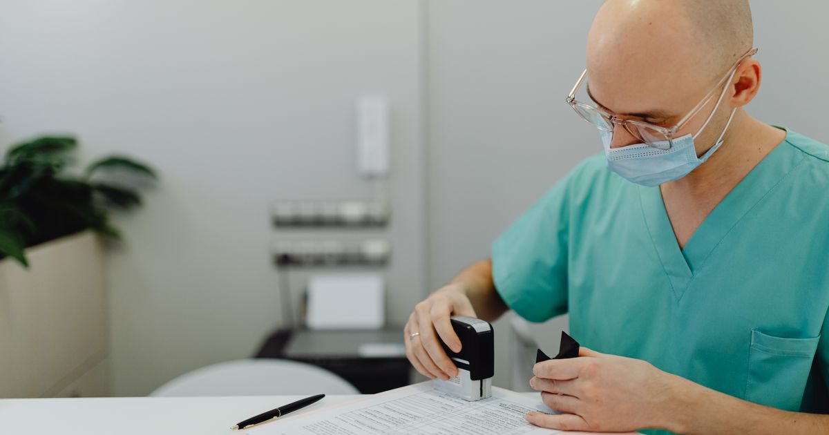 Medical coder reviewing clinical documentation and encounter notes before assigning billing codes Medical coder reviewing clinical documentation and encounter notes before assigning billing codes