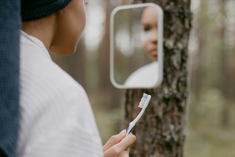 A Person Holding A Toothbrush