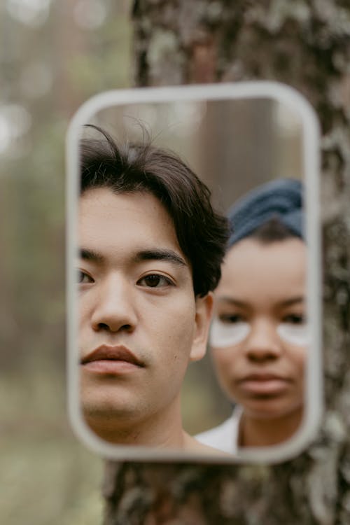 Man and Woman Looking at the Mirror