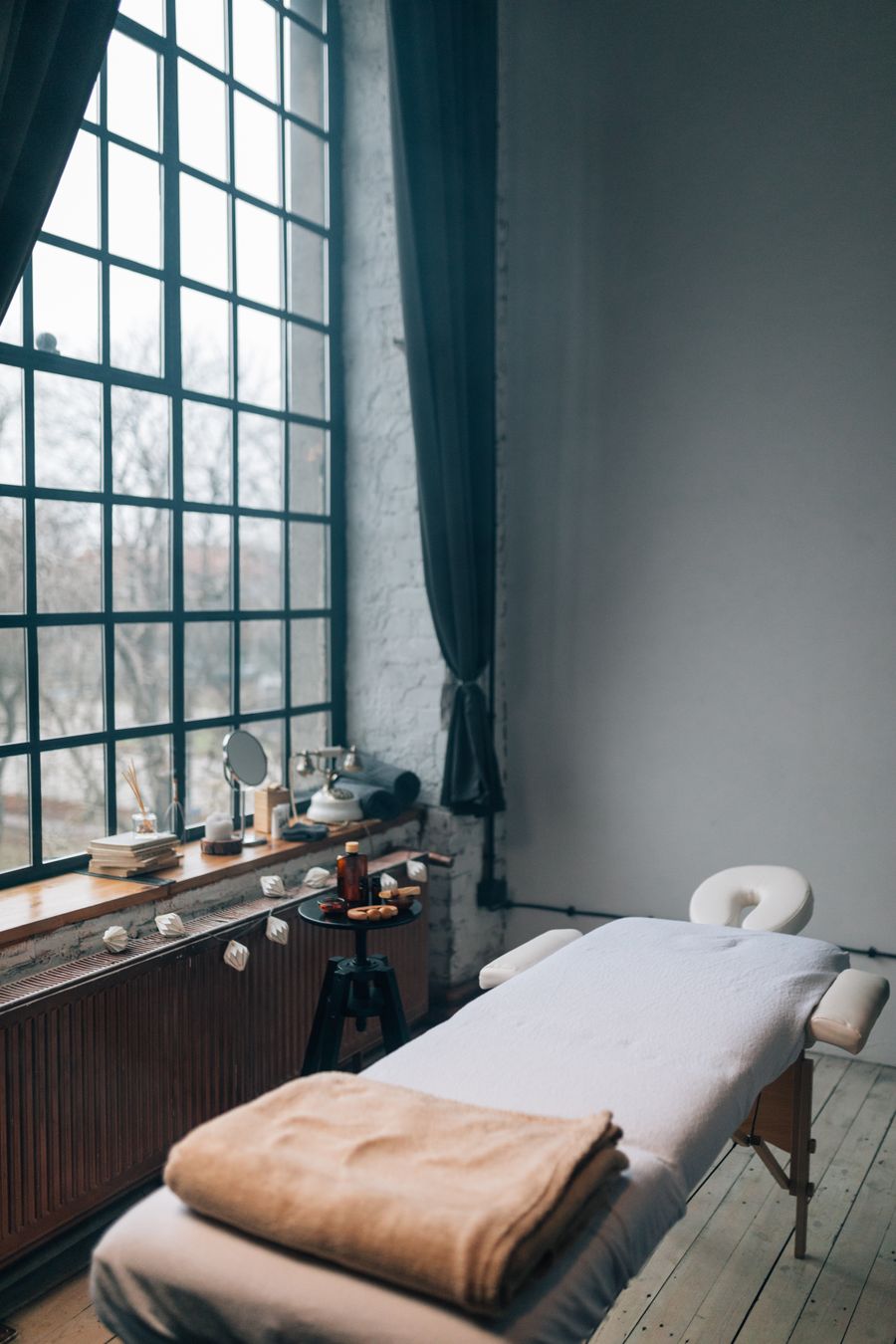 A therapist preparing a treatment room before a guest arrives