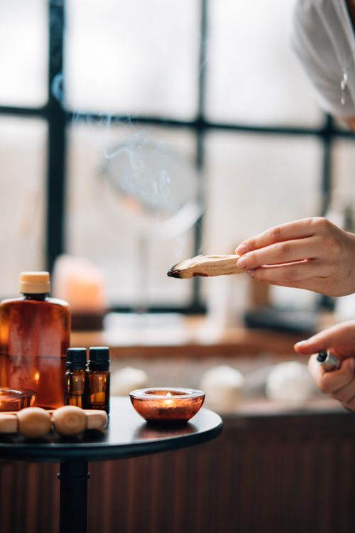 Free A soothing aromatherapy setup featuring burning sage and a lit candle for relaxation. Stock Photo