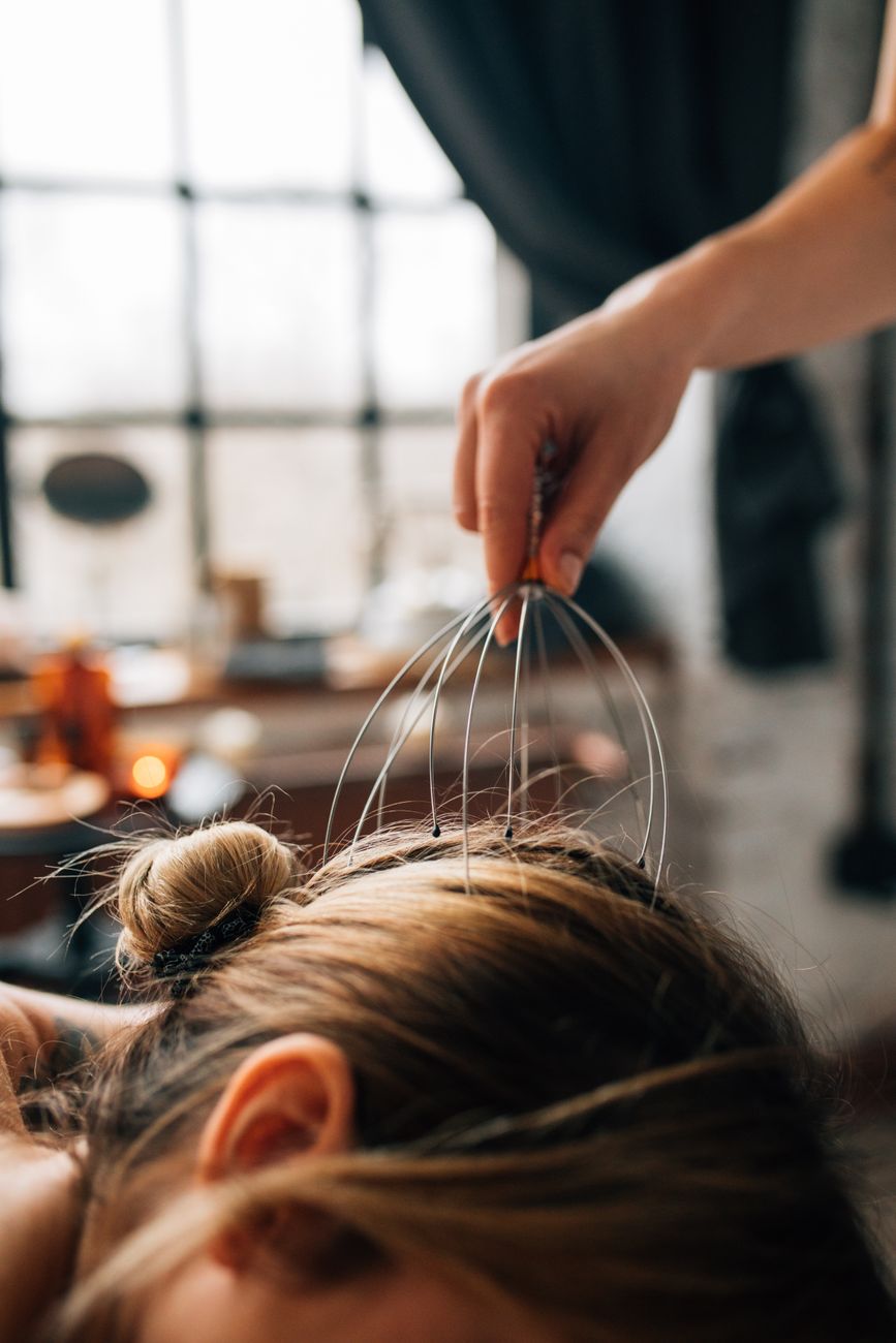 A soothing head massage session indoors, promoting relaxation and self-care.