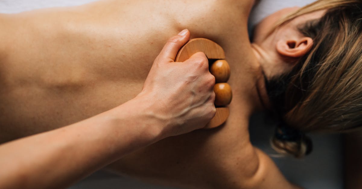 A person receiving a soothing back massage with hot stones.