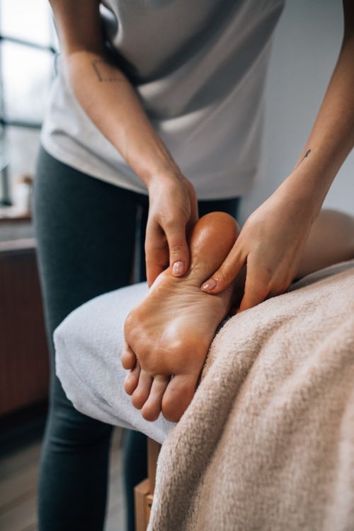 Free Experience ultimate relaxation with a soothing foot massage in a calming indoor environment. Stock Photo