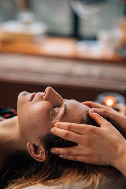 Photo of a Woman Getting a Face Massage