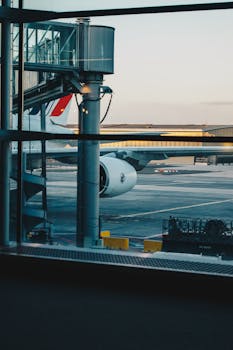 View of an airplane parked at Roissy-en-France airport terminal during dusk.