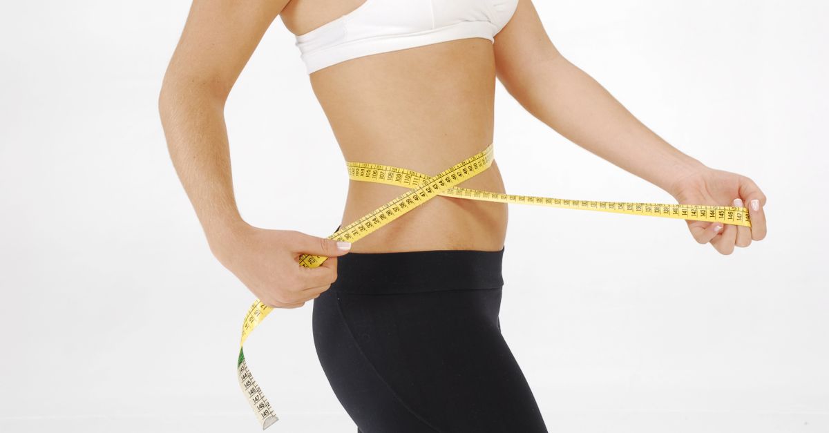 Black woman measuring body composition to understand fat loss vs weight loss difference