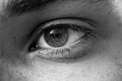 Free Detailed monochrome close-up of a human eye with visible textures and eyelashes. Stock Photo