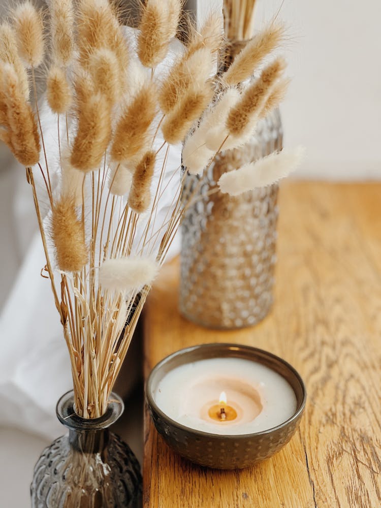 Lighted Candle Near Dried Pampas In A Vase