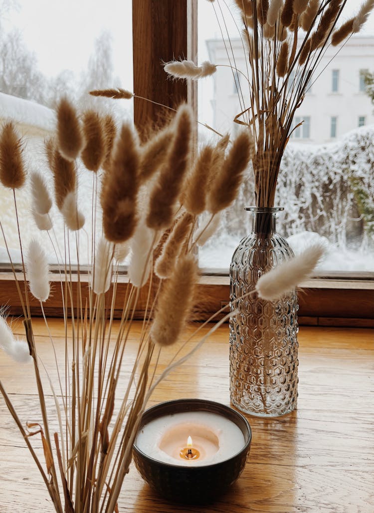 Dried Pampas In A Glass Vase Near A Lighted Candle