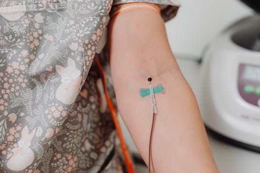 Close-up shot of an intravenous catheter inserted in a patient's arm for medical treatment.