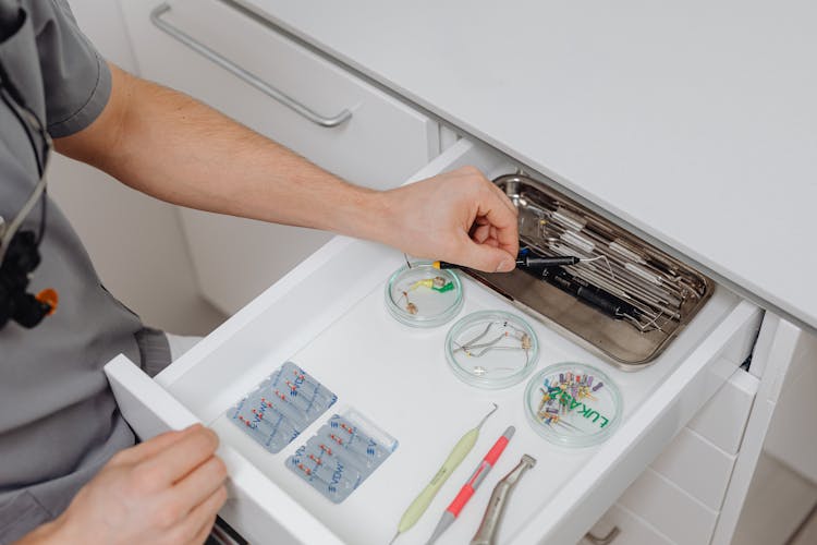 Doctor Taking Medical Tools From Drawer