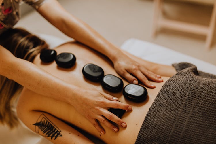 Woman Having A Massage With Massage Stones 