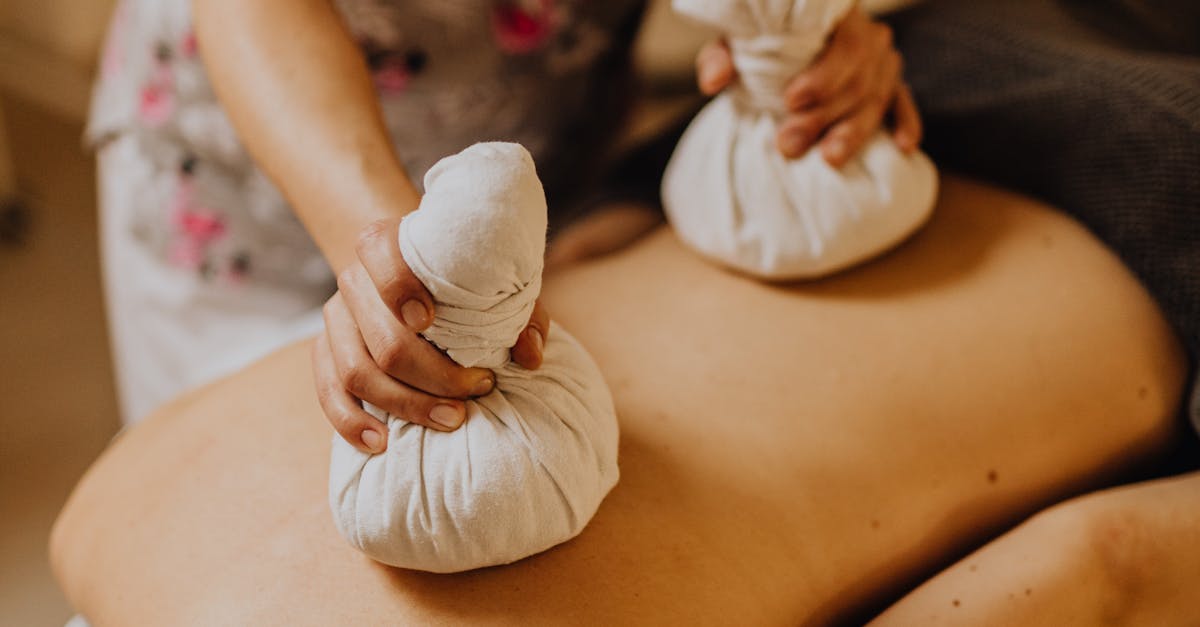Person receiving a relaxing back massage at a spa.