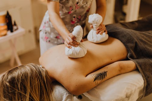 Free 
A Tattooed Woman Having a Massage Stock Photo