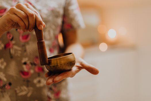 Woman Using Little Gongs for Relaxation 