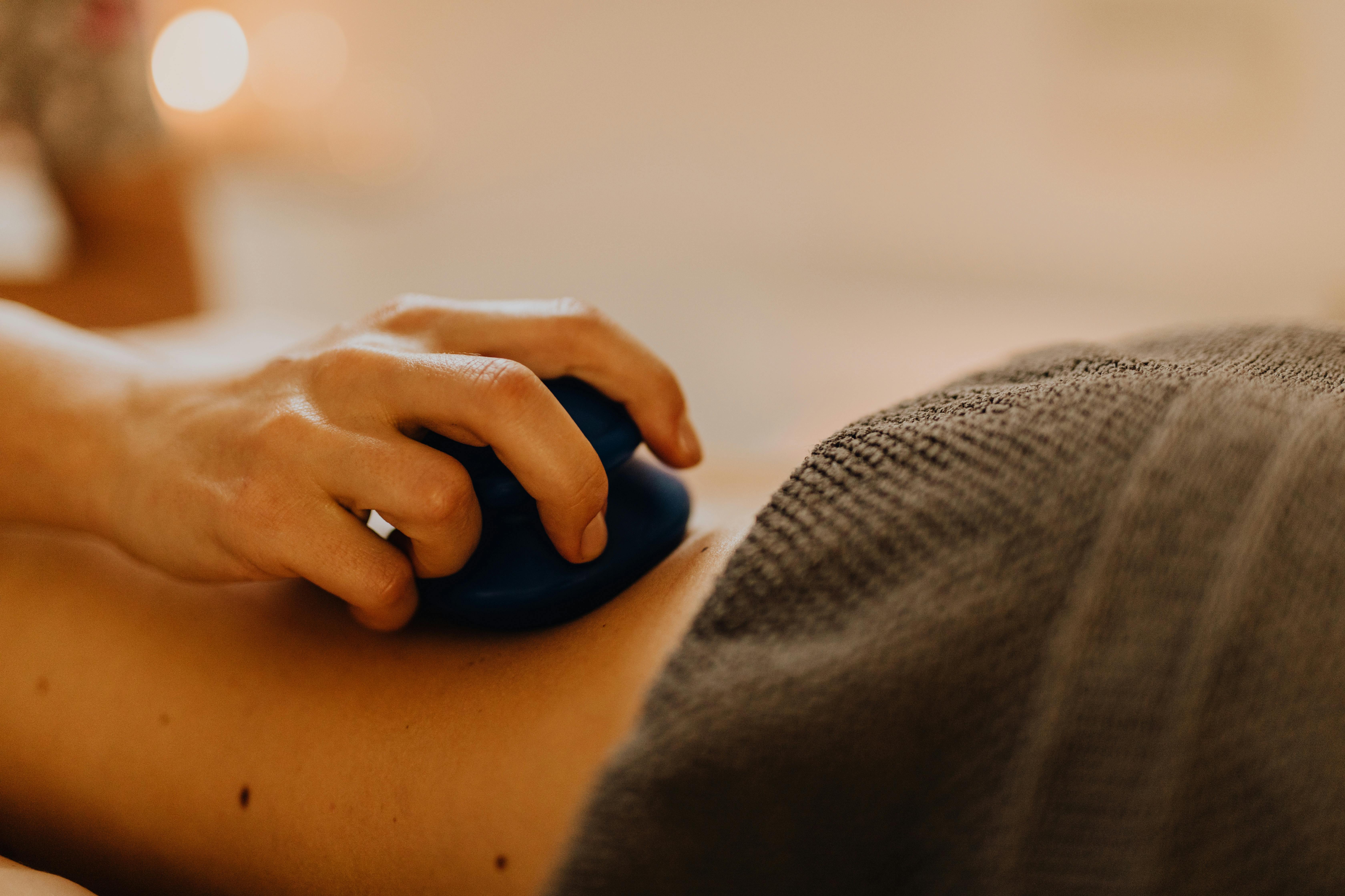 A person receiving a relaxing massage with soft lighting in a calm environment.