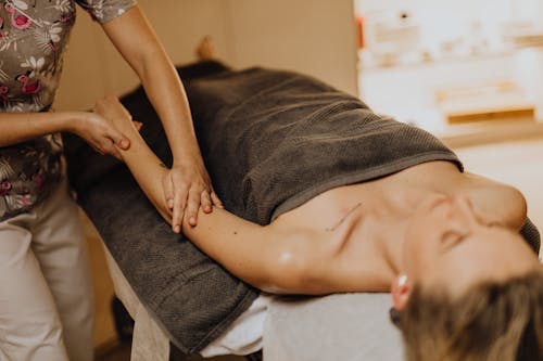 A Masseuse Massaging a Woman's Arm